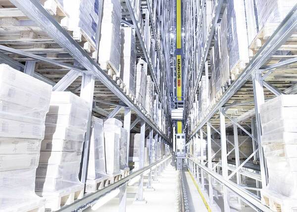 Kranlager som jobber seg mellom reoler med varer. I lyse og fine lokaler.